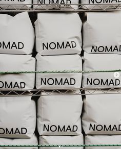 many bags of nomad are stacked on top of each other