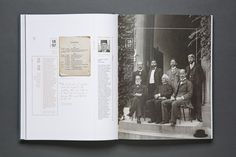 an open book with black and white photos on the pages, showing men in suits