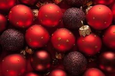 many red christmas ornaments are arranged together