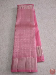 two pink sarees sitting on top of a white table next to each other