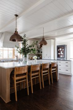 a kitchen with wooden chairs and an island