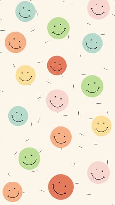 many different colored circles with smiling faces on the side and one has a smile drawn on it