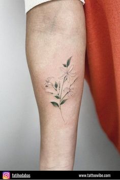 a woman's leg with a flower tattoo on the left side of her arm