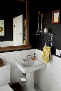 the bathroom is decorated in black and white