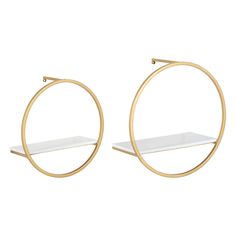 two gold hoop earrings with white shelves on each side