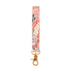 a key chain with flowers on it and a gold metal hook hanging from the end