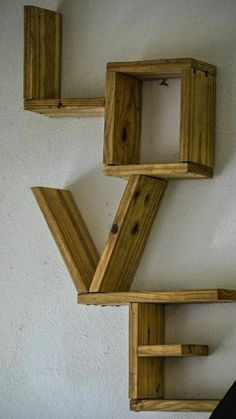 three wooden shelves are arranged on the wall