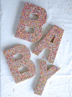 the letters are made out of sprinkles and have been placed on top of each other