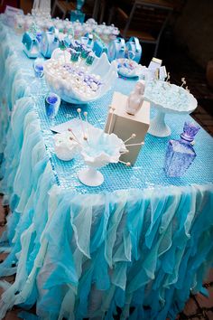 a table topped with blue and white desserts