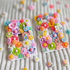 there are two letters made out of flowers on the bed sheet, one is decorated with buttons