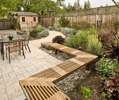 a wooden bench sitting in the middle of a garden