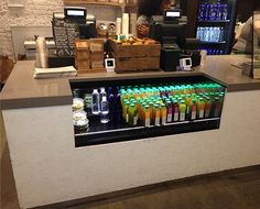 a counter with many different colored bottles on it