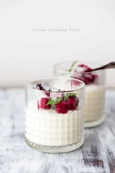 two small glasses filled with food on top of a table