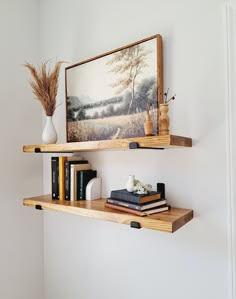 two wooden shelves with books and vases on them