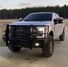 a silver truck is parked on the street