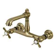 an antique brass faucet with two handles and nozzles on the side