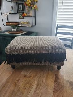 a footstool sitting on top of a wooden floor