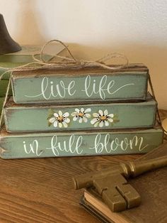 three wooden signs that say live life in full bloom