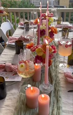 the table is set with candles and wine glasses