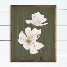 two white flowers painted on wooden planks in a brown and green framed art piece