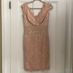 a pink dress hanging on a door