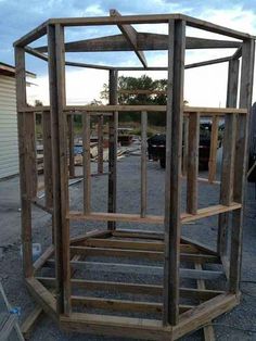 a wooden structure sitting in the middle of a parking lot