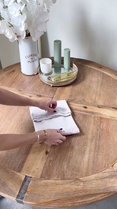 a person sitting at a table writing on a piece of paper