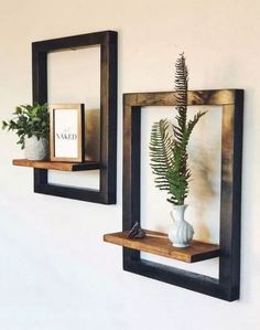 there are two wooden shelves with plants in them on the wall next to each other