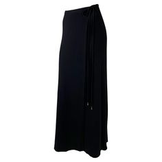 Presenting a chic black wrap maxi skirt designed by Tom Ford for Gucci's Spring/Summer 1997 collection. Constructed in 100% viscose, this stretchy skirt beautifully hugs the wearer. Gold-toned G logo hardware accents the tie closure for a subtle flash. Check out our storefront for more Tom Ford Gucci! Approximate measurements: Size - IT44 27" waist 42" waistband to hem 100% viscose Tom Ford For Gucci, Viscose Skirt, Gucci By Tom Ford, Tom Ford Gucci, Gucci Spring, Ford Black, Stretchy Skirt, Wrap Maxi Skirt, G Logo