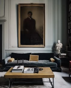 a living room filled with furniture and a painting on the wall