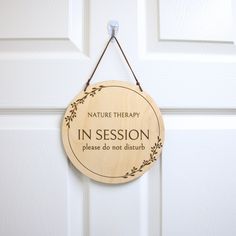 a wooden sign hanging from the side of a door that says, nature therapy in session please do not disturb