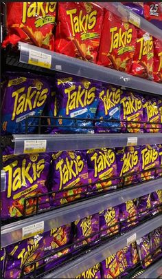 shelves in a grocery store filled with lots of different types of tacos and chips