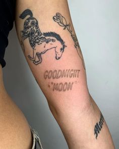 a tattoo on the arm of a woman that says goodnight moon