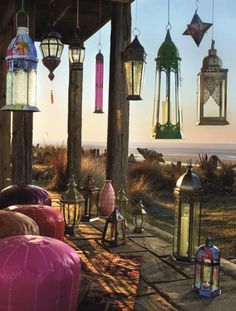 many lanterns hanging from the roof of a building