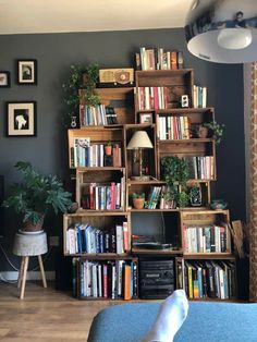 a living room filled with furniture and lots of bookshelves on top of it