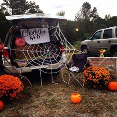 a van with pumpkins and decorations in the back