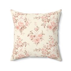 a white pillow with pink flowers on it