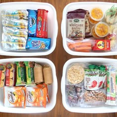 three white containers filled with food on top of a wooden table next to each other