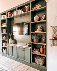 a living room filled with lots of furniture and shelves covered in vases, bookshelves