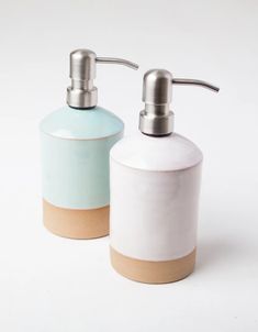 two soap dispensers sitting next to each other