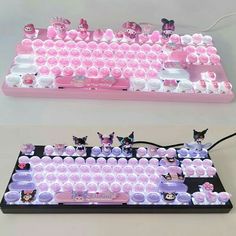 the keyboard is made out of pink and white plastic with little kittens on it