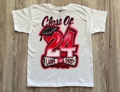 Class of 2024: Celebrate Your Graduation in Style! Rep your year and show your pride with a custom Class of 2024 t-shirt!  These comfortable, high-quality tees are perfect for: Graduation ceremonies: Look unified and spirited as you walk across the stage. Senior year events: From homecoming to prom, rep your class in style. The ultimate graduation keepsake: Commemorate your achievement with a timeless t-shirt you can cherish for years to come. Key features: Soft, breathable fabric: Stay comforta Cute Senior Shirts Ideas, Class Of 2030 Shirt Ideas, 2025 Class Shirts, Senior Year Shirts Design, Class Of 2028 Shirt Ideas, Senior Year Shirts Design 2025, Senior Class Shirts Design 2025, Class Of 2027 Shirt Ideas, Class T Shirt Designs