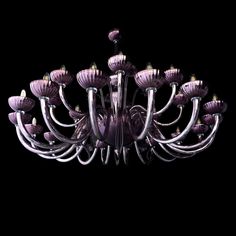 a purple chandelier hanging from the ceiling in front of a black background,