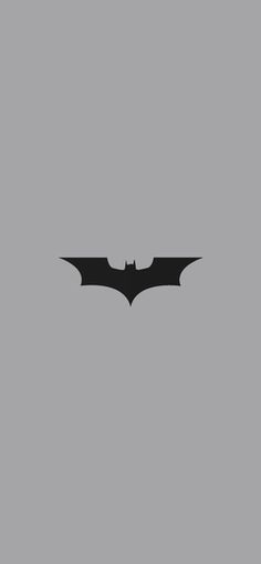 the dark knight rises batman logo on a gray background with black and white text that reads,