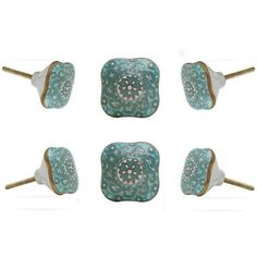 four pieces of blue and white ceramic with gold accents on each side, set against a white background