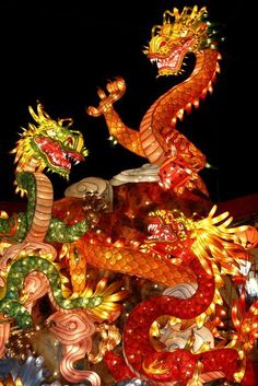 a dragon statue is lit up at night