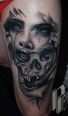 a man's leg with a tattoo on it and a skull in the middle