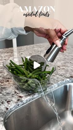 someone is pouring green beans into a bowl