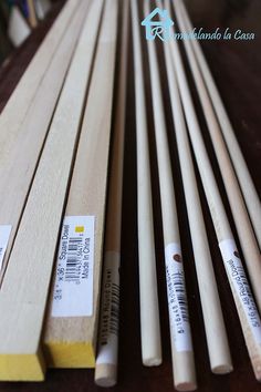 several pieces of wood sitting next to each other on top of a wooden flooring board