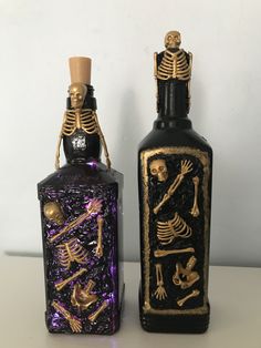 two bottles that have skeletons on them and one has a bottle in the shape of a skeleton